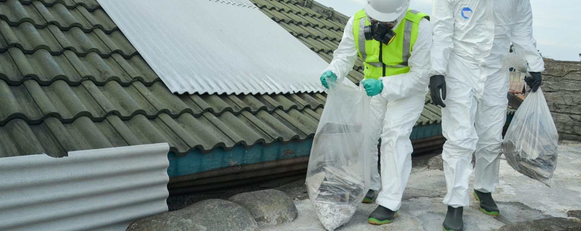 Parts of Asbestos being bagged and removed by Asbestos Removal Operatives